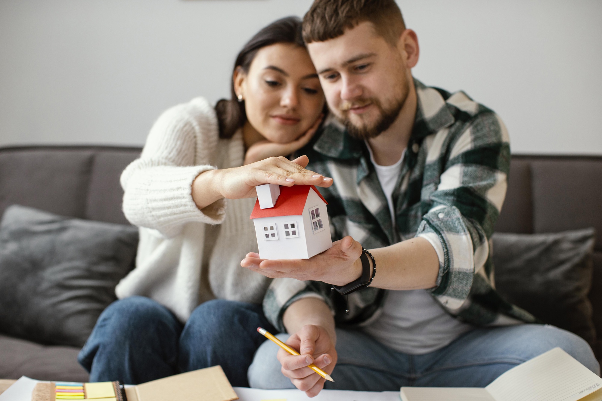couple-holding-small-house-medium-shot