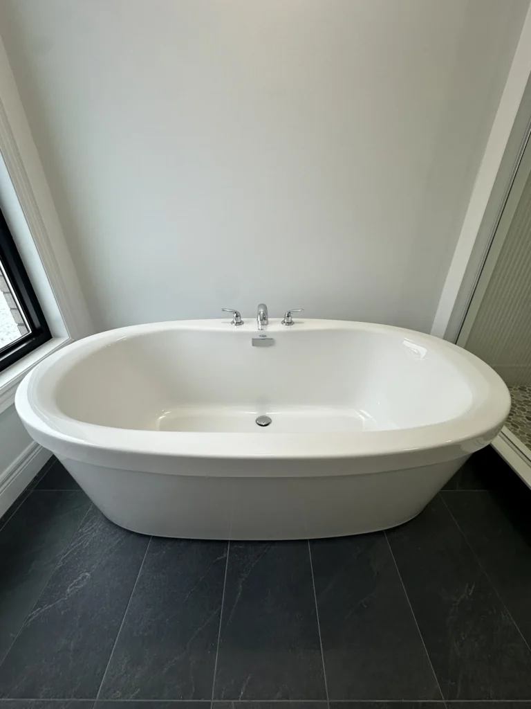 Freestanding soaker tub in a primary ensuite