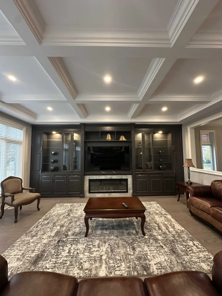 Family room with a dark built-in wall unit and coffered ceiling